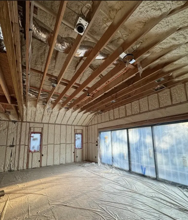 Interior walls and ceiling insulated with spray foam during new construction in Byram